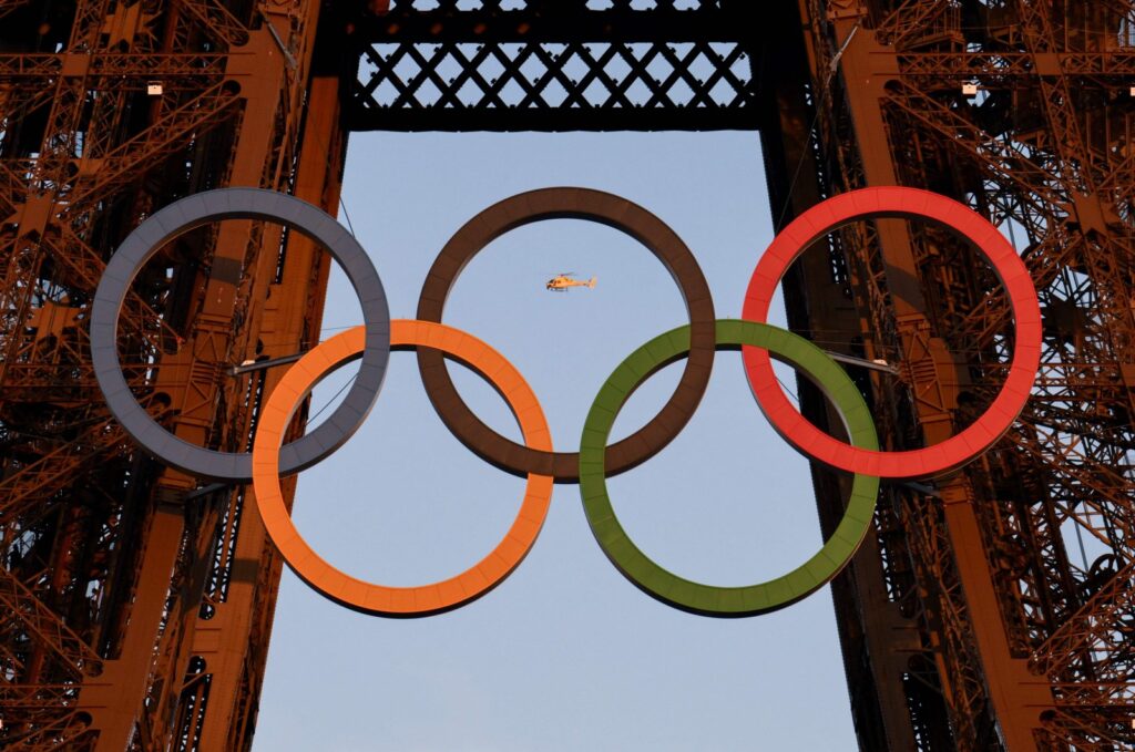 A helicopter flies around the Eiffel Tower with the Olympic rings displayed on it ahead of the Paris 2024 Olympics and Paralympic Games, Paris, France. Photo - AFP