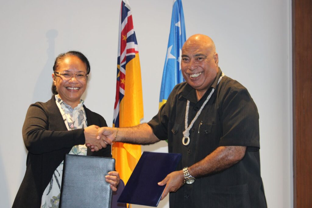 Secretary of the Government of Niue, Ms Peleni Talagi, (left) shakes hands with the Permanent Secretary of Solomon Islands' Ministry of Foreign Affairs and External Trade, Mr. Collin Beck, during the signing of the Inter-Agency Understanding in Tamakautoga, Niue.