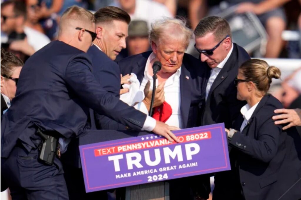 Republican presidential candidate Donald Trump is rushed off the stage after yesterday’s shooting. Photo AP