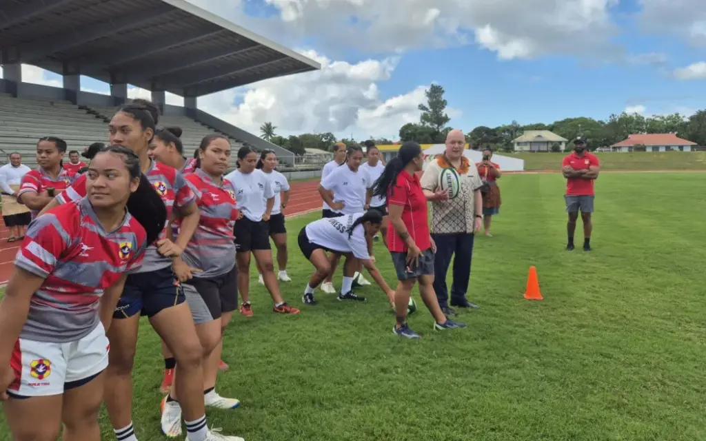 Prime Minister Christopher Luxon gets on the rugby field with some young female players in Tonga, while attending the Pacific Islands Forum leaders meeting. Photo: RNZ / Anneke Smith