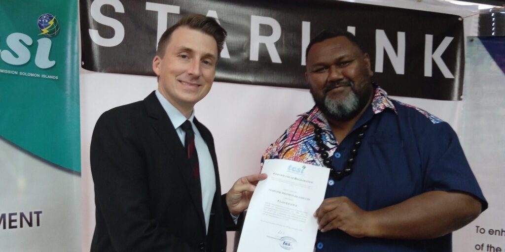 TCSI Commissioner Calvin Ziru right handing over the signed and sealed license to Ryan Goodnight scaled 2560x1280